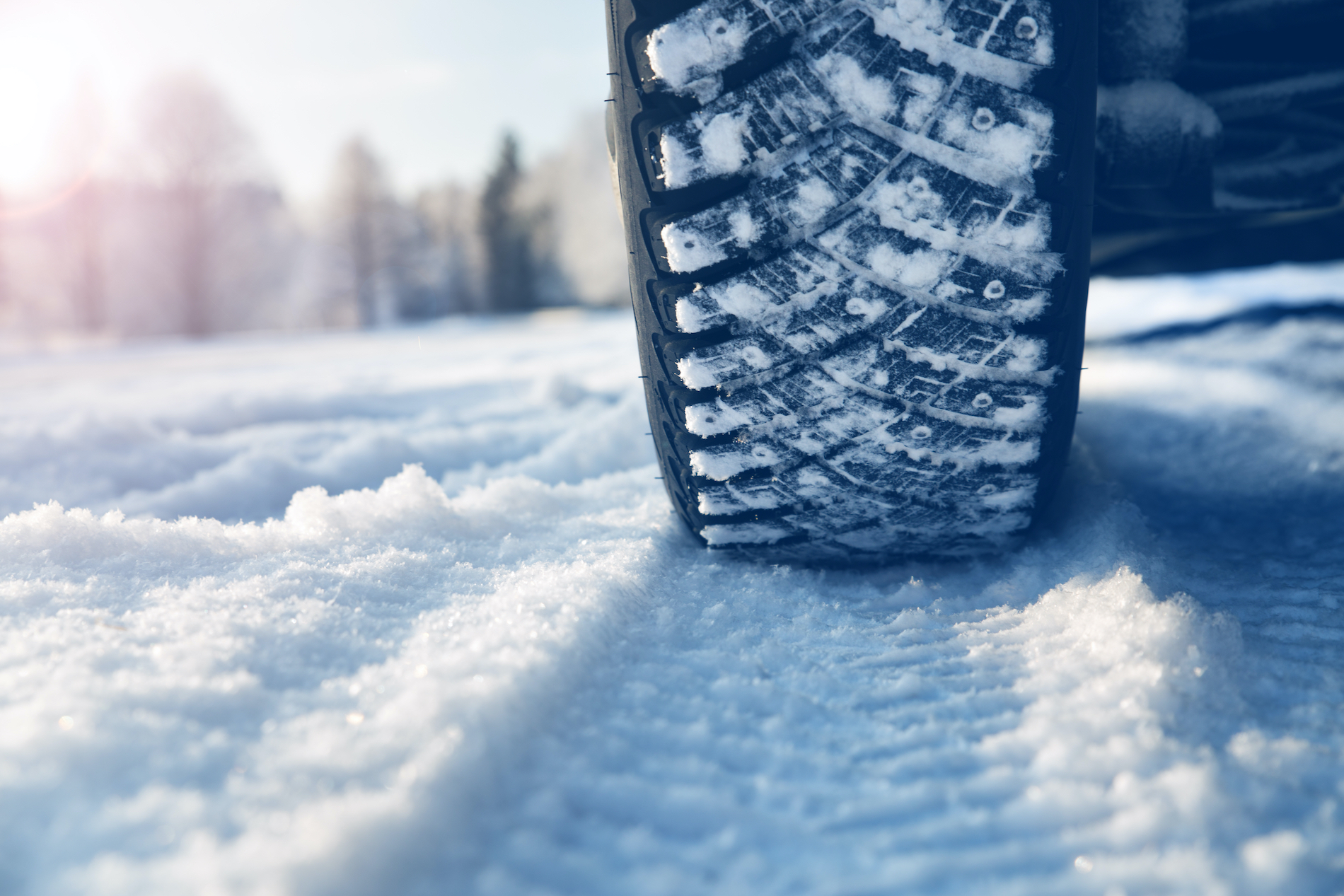 Close up view of a tire driving over snow